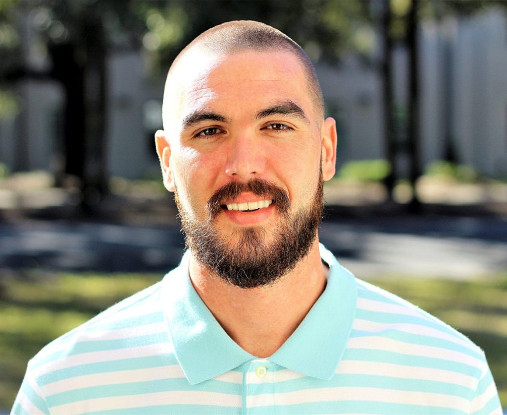 Smiling man outdoors at the Savannah Mission, a free Christian recovery program in Savannah, Georgia